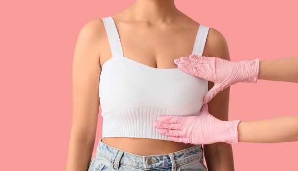 Doctor,Checking,Woman's,Breast,On,Pink,Background.,Cancer,Awareness,Concept